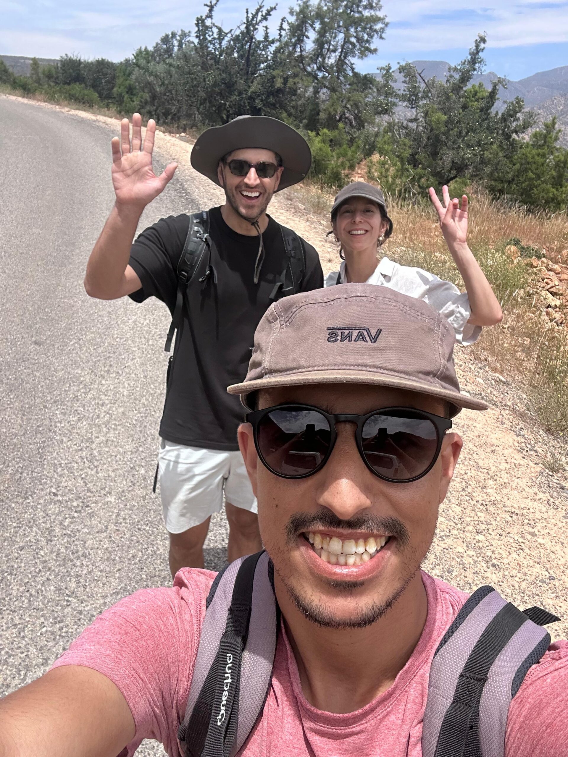 Mohamed, hiking guide at Tizi Hike, with a group of hikers on a trail near Taghazout, Morocco